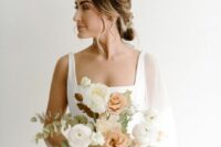 31 a modern wedding bouquet of peachy and white roses and ranunculus, greenery and bold leaves is ideal for a fall wedding