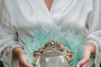 32 a mint green feather tiara with embellishments, pearls and flower brooches is a very chic and bright idea for a wedding