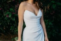 33 a beautiful and sexy strapless wedding dress with a draped bodice and skirt with a thigh high slirt plus nude heels and pearl earrings