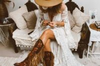 33 a fantastic western bridal look with tall floral pattern and gold fringe cowboy boots, a boho lace A-line wedding dress with bell sleeves and a tan hat