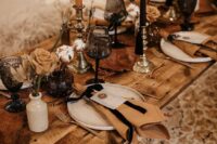 35 a western wedding tablescape with rust roses, black and rust candles, rust napkins and cotton is a cool idea for a boho wedding