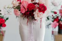 37 a colorful modern wedding bouquet of blush roses, red peony roses, pink fronds and anturium plus long ribbon