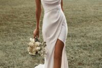 37 a delicate modern wedding dress with a draped bodice, spaghetti straps, a draped skirt with a slit and a train is amazing