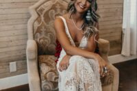 37 an A-line boho lace wedding dress with thick straps, a covered plunging neckline, a train, neutral embellished cowbo boots and statement jewelry
