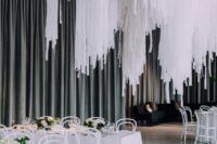 38 a pure white wedding reception with white tables, chairs and blooms and a huge wedding installation of white streamers over the space