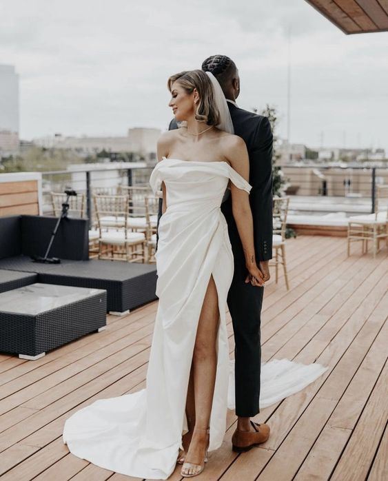 a pretty modern off the shoulder mermaid wedding dress with a draped bodice and skirt, a train is classics