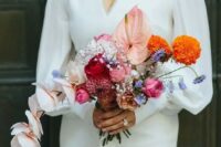 44 a stylish and catchy modern wedding bouquet of pink, red and blush blooms, orange and blue ones plus orchids is a cool idea for a modern bride