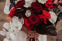 46 an extra bold and dramatic wedding bouquet of white, red and burgundy roses, dark anthurium and leaves, white orchids and pink foliage