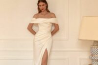 47 a beautiful and chic off the shoulder wedding dress with a draped neckline, bodice and skirt, a thigh high slit and a train is very sophisticated