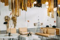 47 a warehouse wedding lounge with stylish furniture, some blooms and black and gold tinsel fringe over the space