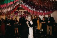 49 a wedding dance floor decorated with gold, burgundy, emerald and red streamers and a disco ball is a fantastic idea