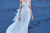 49 an off the shoulder flowy wedding dress with a draped embellished bodice and a flowy skirt