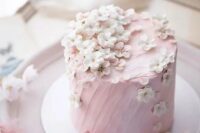 a delicate light pink wedding cake with fresh cherry blossom is an ideal solution for a spring wedding, it looks amazing
