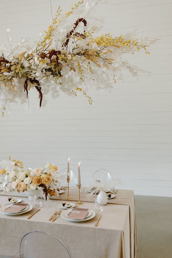 a dried grass wedding installation with lunarias, yellow blooms and amaranthus plus branches is a chic idea for a fall wedding