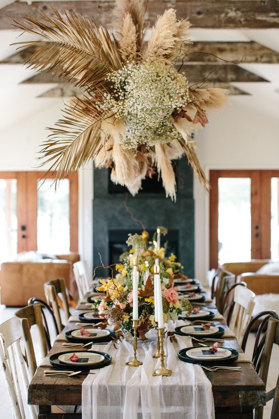 a dried leaf and grass wedding installation with some baby's breath, branches is a lovely idea for a boho wedding