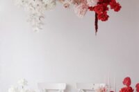 a fabulous ombre floral wedding installation of white, blush and red roses, orchids, dahlias and anthurium is just jaw-dropping