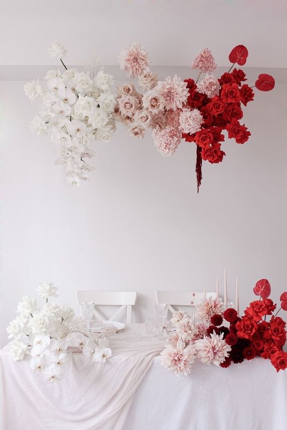 a fabulous ombre floral wedding installation of white, blush and red roses, orchids, dahlias and anthurium is just jaw-dropping