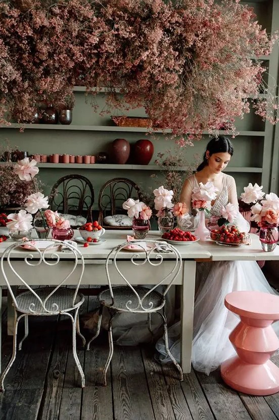 a fantastic overhead floral installation of pink blooms and blush roses on the table for a refined vintage feel