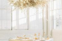 a floating overhead wedding installation of white lunaria and some branches will be an ethereal solution for a spring wedding