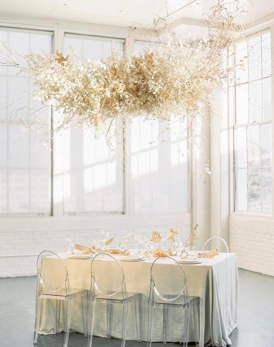 a floating overhead wedding installation of white lunaria and some branches will be an ethereal solution for a spring wedding