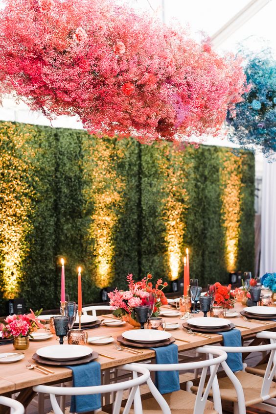 a gorgeous color block floral wedding installation of pink and blue baby's breath matching the table decor is amazing