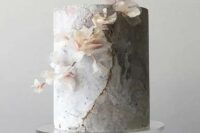 a grey marble wedding cake with gold touches and a blooming branch is an ethereal solution for a modern refined wedding