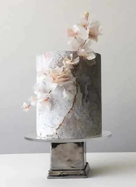 a grey marble wedding cake with gold touches and a blooming branch is an ethereal solution for a modern refined wedding
