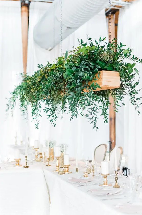 a hanging wooden box with lush greenery will instantly add freshness to the reception
