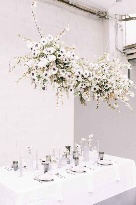 a lovely and cool white anemone wedding nstallation with some blooming cherry branches is a gorgeous idea to decorate over the reception