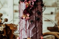 a mauve textural wedding cake with dark blooms and greenery, with fresh fruit and berries is a bold and cool idea for the fall