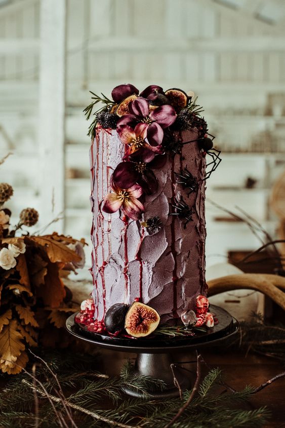 a mauve textural wedding cake with dark blooms and greenery, with fresh fruit and berries is a bold and cool idea for the fall