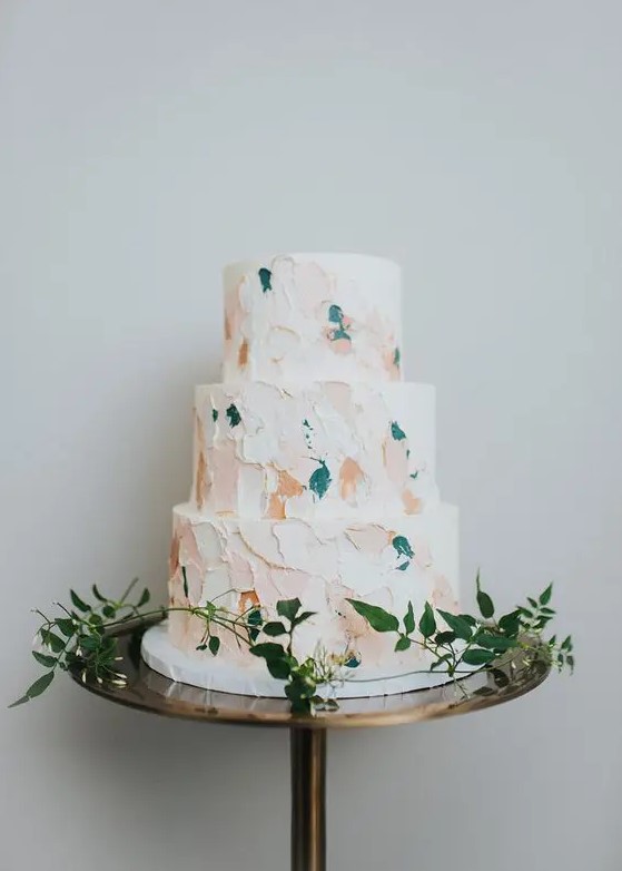 a modern wedding cake with pastel and teal brushstrokes is a fresh idea for a modern wedding and it looks non-boring