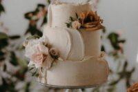 a neutral textural wedding cake with a raw edge and some neutral blooms and greenery is a chic idea for a spring wedding