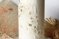 a neutral textural wedding cake with gold glitter and a raw edge is a sophisticated idea for a spring or summer wedding