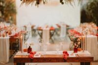 a pink pampas grass and eucalyptus wedding installation with matching arrangements at the table is a lovely idea