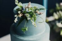 a serenity blue wedding cake with textural buttercream covered tiers and some fresh blooms and greenery on top is a gorgeous idea for spring