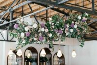 a sophisticated overhead wedding installation with blush, pink and purple blooms and greenery is a beautiful decor idea for a wedding