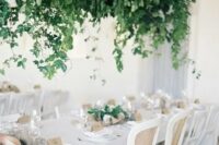a super lush cascading wedding decoration overhead enlivens the neutral wedding reception