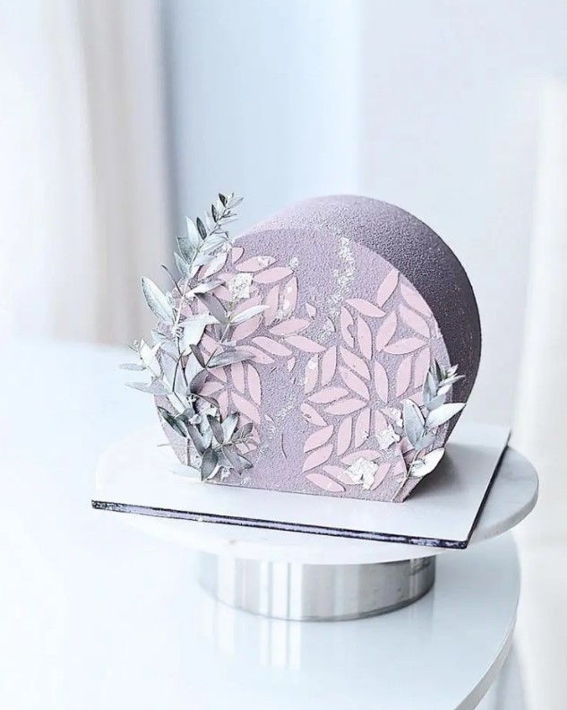 a wintry textured top forward wedding cake decorated with blue dried grasses and pink petals is a gorgeous idea to go for