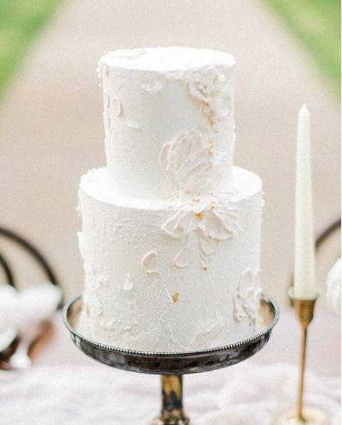 an airy neutral wedding cake with texture and floral patterns on it is a very refined and beautiful idea to rock