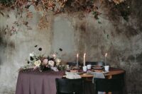 an oversized dark wedding installation of dried blooms, foliage and branches for a sophisticated moody wedding in the fall