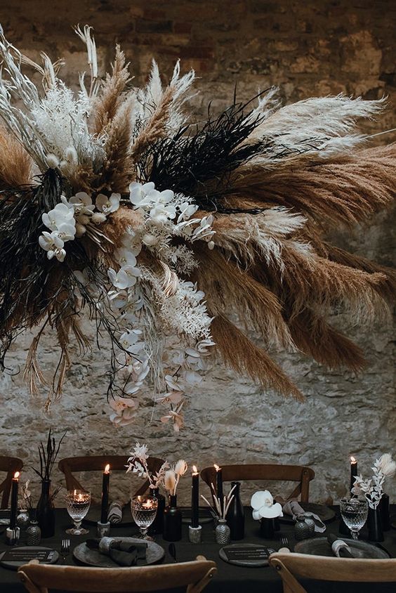 an oversized wedding installation of usual and dyed pampas grass, branches and white orchids will bring a wow factor to the space