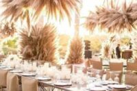large and cool pampas grass overhead wedding installations and pillars will make your wedding reception boho and cool