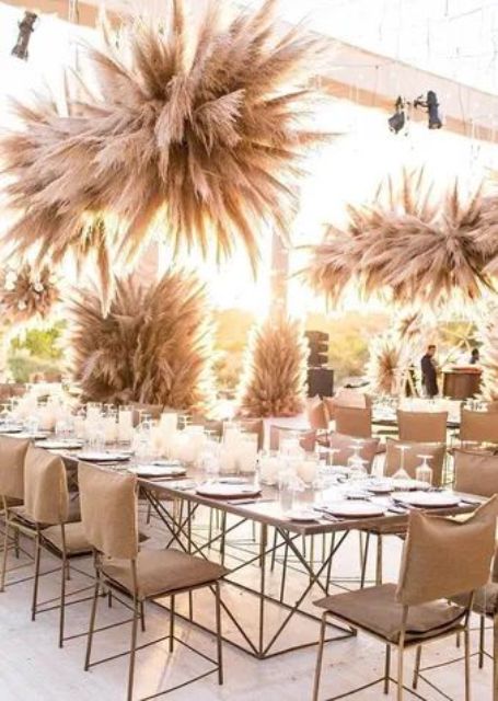 large and cool pampas grass overhead wedding installations and pillars will make your wedding reception boho and cool