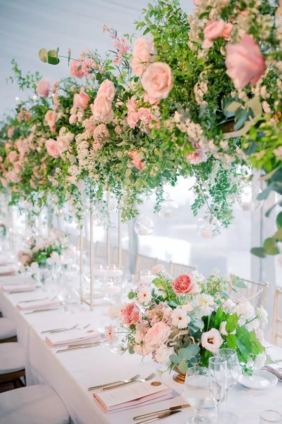 refined wedding table decor with tall and large blush wedding centerpieces that are doubled in the on-table floral arrangements