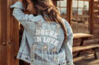 03 a bleached denim jacket with letters, embellished stars with long crystal fringe is a super cool boho and glam idea