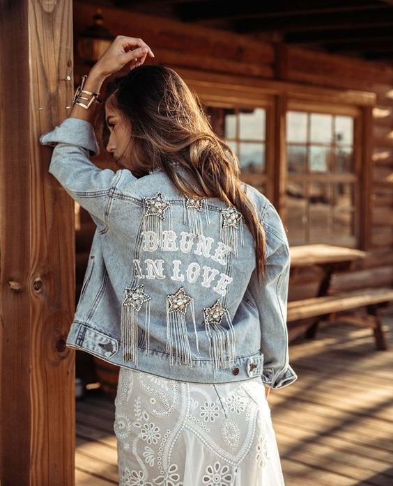 a bleached denim jacket with letters, embellished stars with long crystal fringe is a super cool boho and glam idea