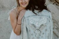 04 a bleached denim jacket with silver fringe, white calligraphy, crystals, embellished stars and sequins for a boho bridal look