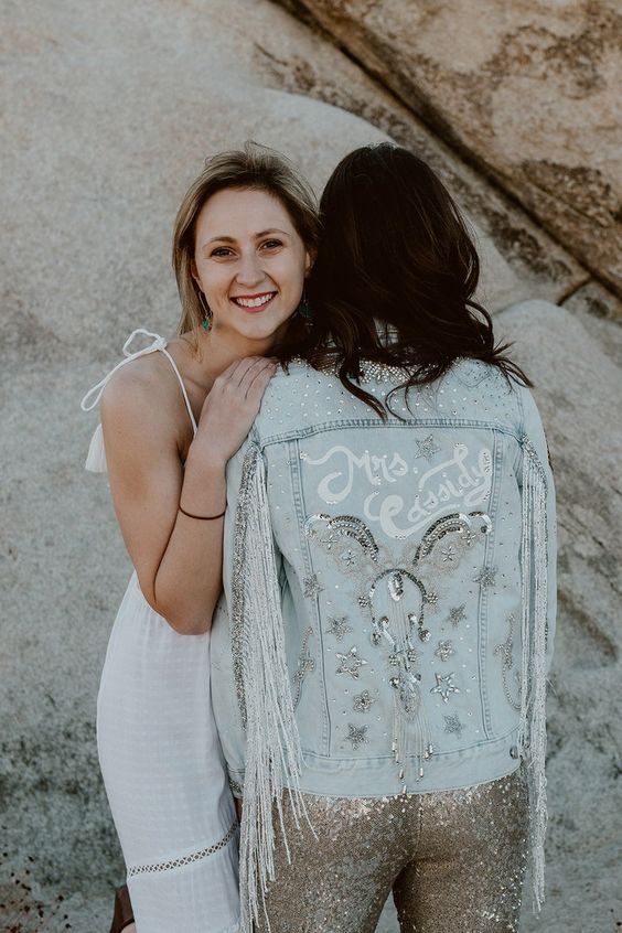 a bleached denim jacket with silver fringe, white calligraphy, crystals, embellished stars and sequins for a boho bridal look