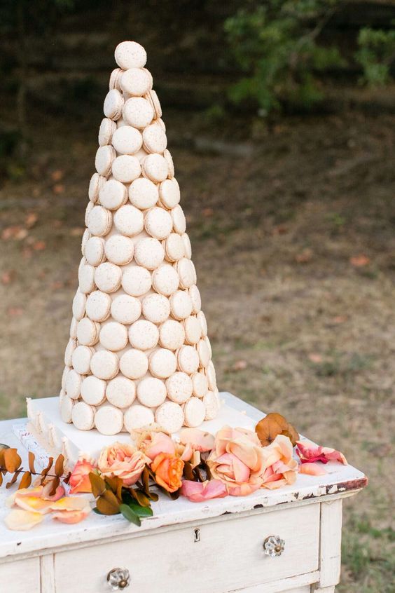 a large white macaron tower is a cool alternative to a usual wedding cake, it looks very elegant